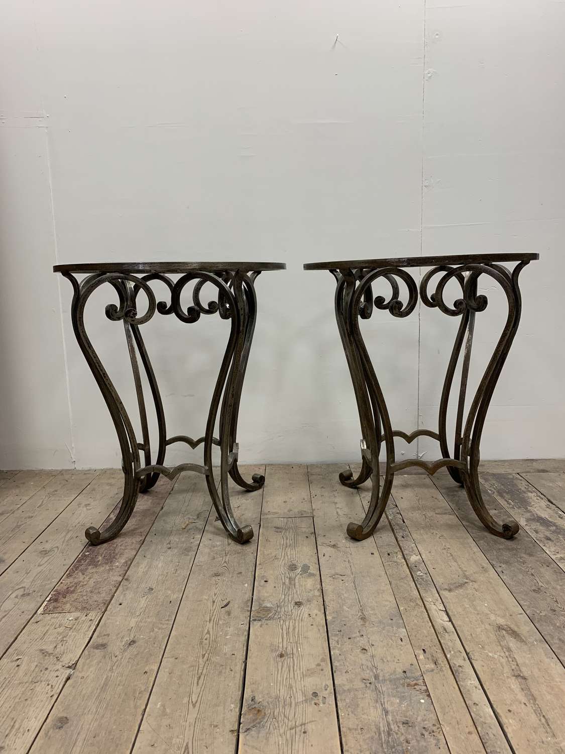 1970s pair of wrought iron side tables with glass tops