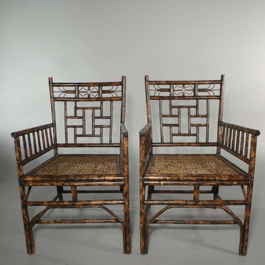Circa 1970s vintage colonial style pair of bamboo armchairs with caned seats